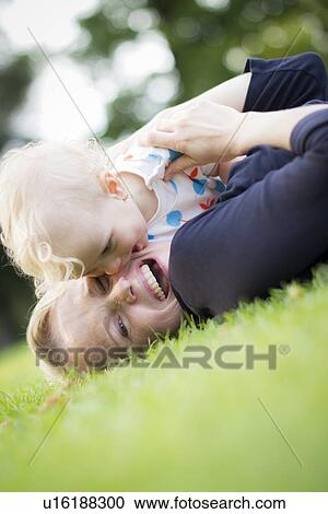 Mother and baby playing in grass View Large Photo Image Stock Image - Mother and baby playing in grass. Fotosearch