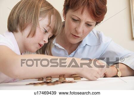 Mother and daughter counting coins View Large Photo Image Stock Photo - Mother and daughter counting coins. Fotosearch