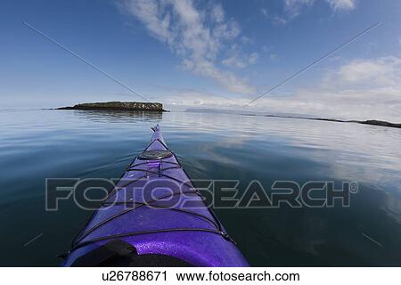 Stock Image - Nose of kayak on still lake. Fotosearch