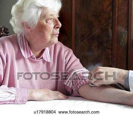 Older woman having pulse checked View Large Photo Image Picture - Older woman having pulse checked. Fotosearch