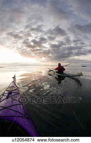 People kayaking on still lake View Large Photo Image Picture - People kayaking on still lake. Fotosearch