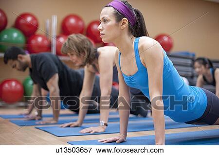 People practicing yoga in studio View Large Photo Image Stock Photo - People practicing yoga in studio. Fotosearch
