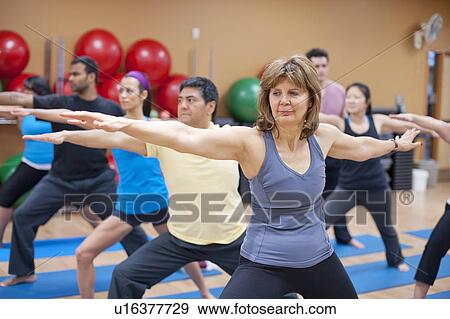 People practicing yoga in studio View Large Photo Image Stock Photo - People practicing yoga in studio. Fotosearch