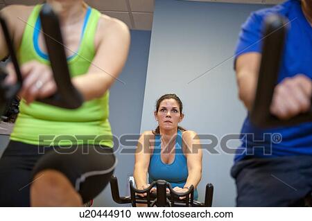 People using spin machines in gym View Large Photo Image Stock Image - People using spin machines in gym. Fotosearch