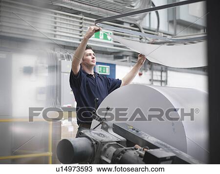 Printer checking paper feed of press View Large Photo Image Stock Image - Printer checking paper feed of press. Fotosearch