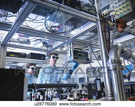 Scientist adjusting oscilloscope in lab View Large Photo Image Stock Photo - Scientist adjusting oscilloscope in lab. Fotosearch