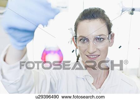 Scientist examining liquid in lab View Large Photo Image Stock Image - Scientist examining liquid in lab. Fotosearch