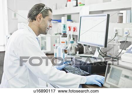 Scientist using computer in lab View Large Photo Image Stock Photo - Scientist using computer in lab. Fotosearch