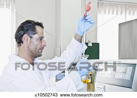 Scientist with pipette of liquid View Large Photo Image Stock Image - Scientist with pipette of liquid. Fotosearch