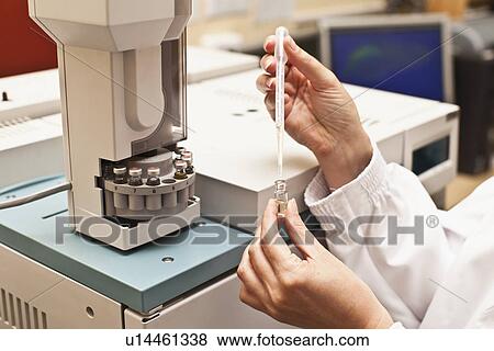 Stock Photo - Scientist with pipette of liquid. Fotosearch