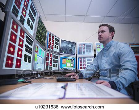 Stock Photograph - Scientist working on computers in lab. Fotosearch