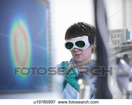 Stock Photo - Scientist working with vacuum in lab. Fotosearch
