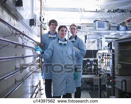 Stock Image - Scientists standing together in lab. Fotosearch