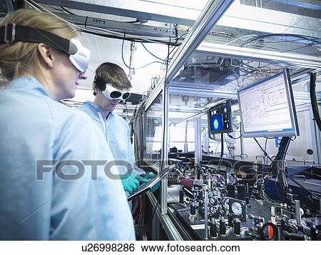 Stock Photograph - Scientists talking in lab. Fotosearch