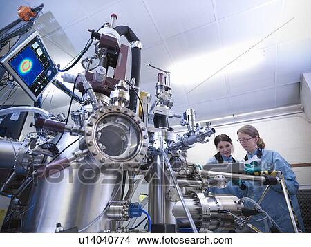 Picture - Scientists using vacuum chamber in lab. Fotosearch