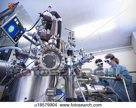 Scientists using vacuum chamber in lab View Large Photo Image Picture - Scientists using vacuum chamber in lab. Fotosearch