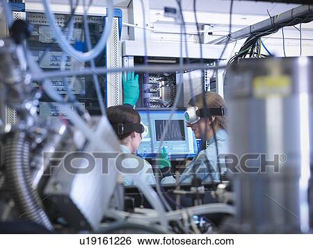 Stock Photograph - Scientists working at computer in lab. Fotosearch