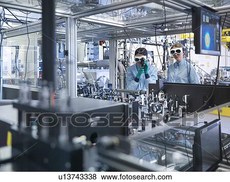 Scientists working together in lab View Large Photo Image Stock Photo - Scientists working together in lab. Fotosearch