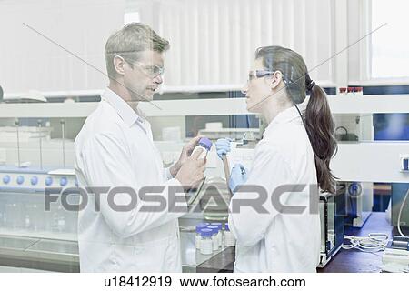 Stock Photo - Scientists working together in lab. Fotosearch
