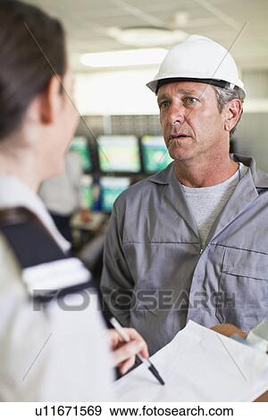 Security personnel talking to worker View Large Photo Image Stock Photo - Security personnel talking to worker. Fotosearch