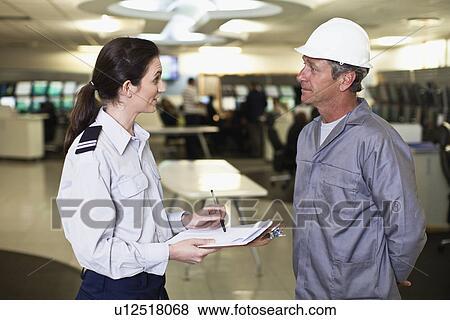 Security personnel talking to worker View Large Photo Image Stock Photo - Security personnel talking to worker. Fotosearch