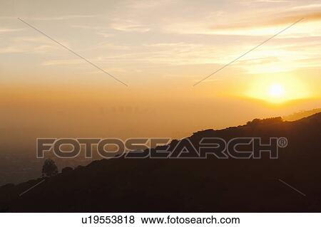 Stock Photo - Silhouette of hillside at sunset. Fotosearch