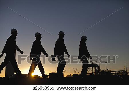 Stock Photography - Silhouette of workers at oil refinery. Fotosearch