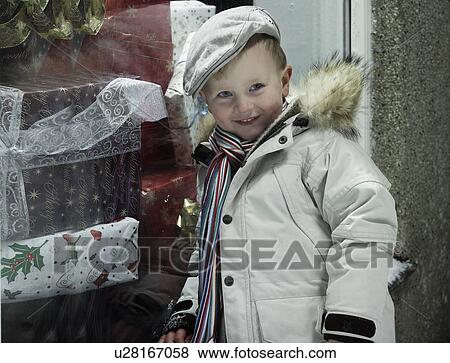 Smiling boy standing in snow View Large Photo Image Stock Photo - Smiling boy standing in snow. Fotosearch