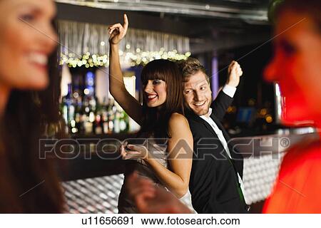Smiling friends dancing in bar View Large Photo Image Stock Image - Smiling friends dancing in bar. Fotosearch