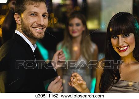 Smiling friends dancing in bar View Large Photo Image Stock Image - Smiling friends dancing in bar. Fotosearch