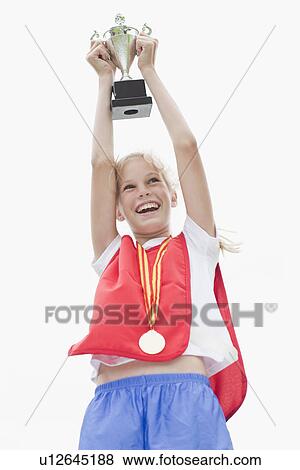 Stock Photo - Smiling girl holding trophy. Fotosearch