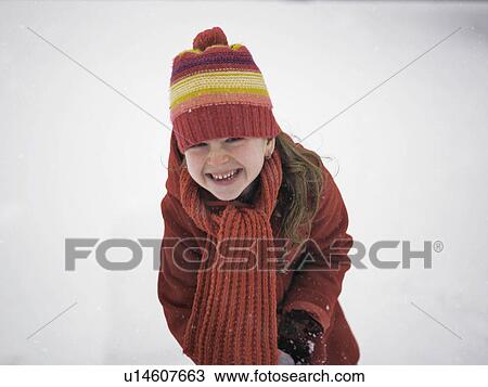 Smiling girl playing in snow View Large Photo Image Stock Image - Smiling girl playing in snow. Fotosearch