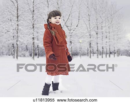 Stock Photography - Smiling girl playing in snow. Fotosearch