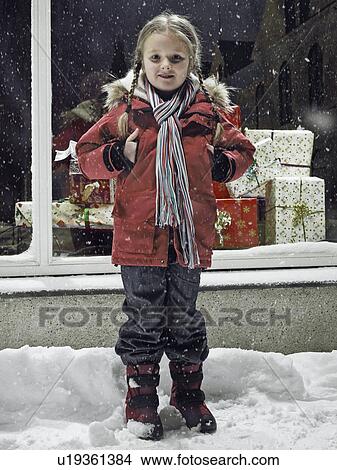 Picture - Smiling girl standing in snow. Fotosearch