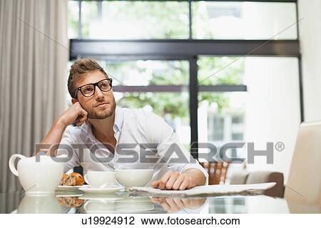 Smiling man sitting at breakfast View Large Photo Image Stock Image - Smiling man sitting at breakfast. Fotosearch