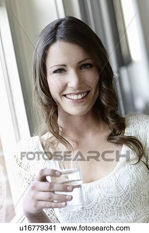 Smiling woman drinking glass of water View Large Photo Image Stock Image - Smiling woman drinking glass of water. Fotosearch