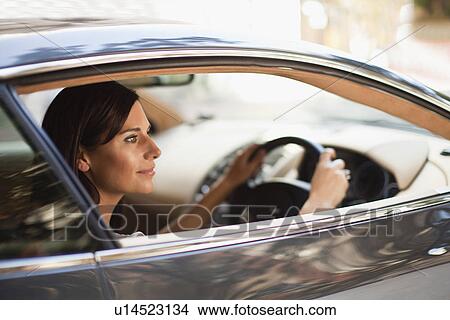 Smiling woman driving sports car View Large Photo Image Picture - Smiling woman driving sports car. Fotosearch