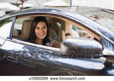 Smiling woman driving sports car View Large Photo Image Stock Photo - Smiling woman driving sports car. Fotosearch