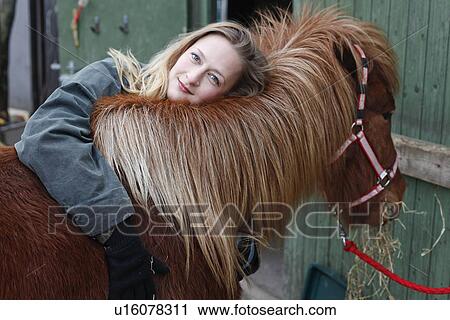 Smiling woman hugging horse outdoors View Large Photo Image Stock Image - Smiling woman hugging horse outdoors. Fotosearch