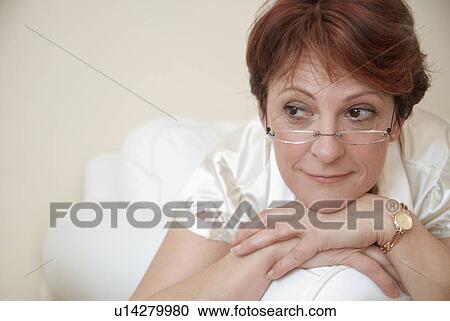 Smiling woman resting chin in hands View Large Photo Image Stock Image - Smiling woman resting chin in hands. Fotosearch