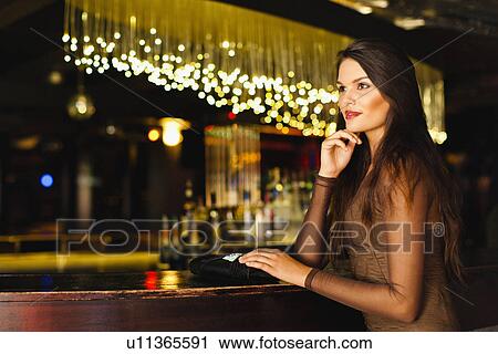 Smiling woman standing at bar View Large Photo Image Stock Image - Smiling woman standing at bar. Fotosearch