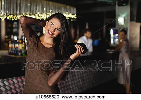Smiling woman standing in bar View Large Photo Image Stock Image - Smiling woman standing in bar. Fotosearch