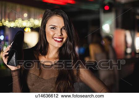 Smiling woman standing in bar View Large Photo Image Stock Image - Smiling woman standing in bar. Fotosearch
