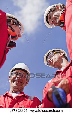 Smiling workers talking outdoors View Large Photo Image Picture - Smiling workers talking outdoors. Fotosearch