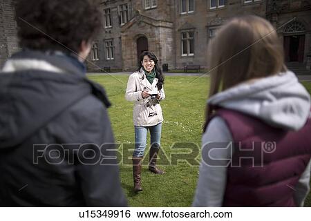 Stock Photograph - Student taking picture of friends. Fotosearch