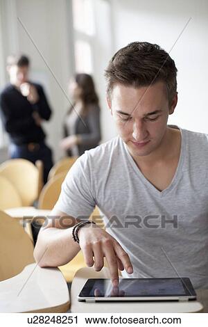 Student working on tablet computer View Large Photo Image Stock Image - Student working on tablet computer. Fotosearch