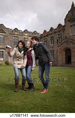 Students laughing together on campus View Large Photo Image Stock Image - Students laughing together on campus. Fotosearch