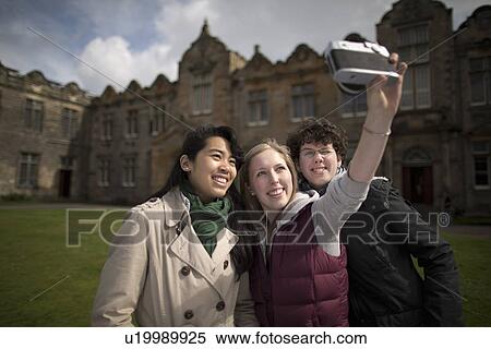 Stock Photography - Students taking pictures of themselves. Fotosearch