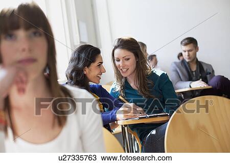 Stock Image - Students talking in classroom. Fotosearch