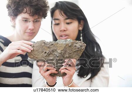 Stock Image - Students working in geology lab. Fotosearch